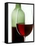 Red Wine Glass with Half-Full Wine Bottle in Background-Joerg Lehmann-Framed Stretched Canvas