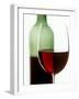 Red Wine Glass with Half-Full Wine Bottle in Background-Joerg Lehmann-Framed Photographic Print