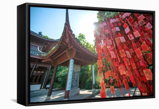 Red Wooden Traditional Chinese Good Luck Charms and Pagoda in Background, Hangzhou, Zhejiang, China-Andreas Brandl-Framed Stretched Canvas