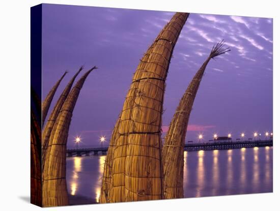 Reed Boats are Stacked Along the Beach at the Fishing Village of Huanchaco in Northern Peru-Andrew Watson-Stretched Canvas