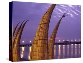 Reed Boats are Stacked Along the Beach at the Fishing Village of Huanchaco in Northern Peru-Andrew Watson-Stretched Canvas