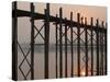 Reflection in Water and Buddhist Monk Silhouetted at Sunrise Crossing U Bein Teak Bridge-Stephen Studd-Stretched Canvas