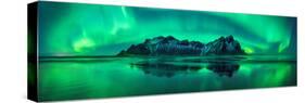 Reflection of Aurora Borealis in the sea with Vestrahorn mountains in center, Stokksnes Beach, S...-null-Stretched Canvas