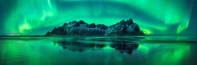 https://imgc.allpostersimages.com/img/posters/reflection-of-aurora-borealis-in-the-sea-with-vestrahorn-mountains-in-center-stokksnes-beach-s_u-L-Q1C09CQ0.jpg?artPerspective=n