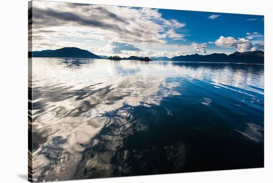 Reflections in the calm waters of the Inside Passage, Southeast Alaska, USA-Mark A Johnson-Stretched Canvas
