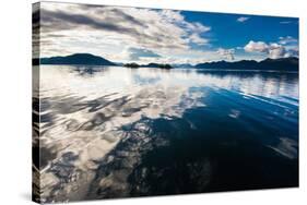 Reflections in the calm waters of the Inside Passage, Southeast Alaska, USA-Mark A Johnson-Stretched Canvas