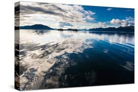 Reflections in the calm waters of the Inside Passage, Southeast Alaska, USA-Mark A Johnson-Stretched Canvas