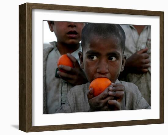 Refugee Boys Eat Tangerines at a Small Refugee Camp-null-Framed Photographic Print