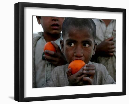 Refugee Boys Eat Tangerines at a Small Refugee Camp-null-Framed Photographic Print
