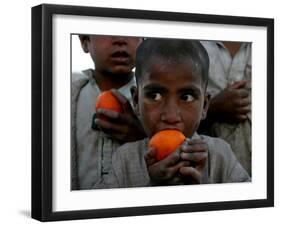 Refugee Boys Eat Tangerines at a Small Refugee Camp-null-Framed Photographic Print