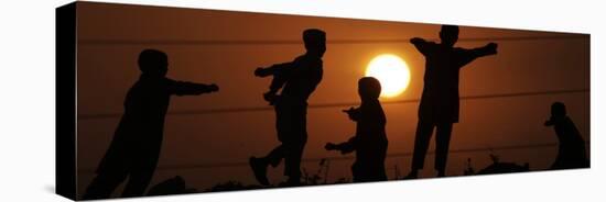 Refugee Children Playing on a Railway Near their Camp at Sunset, in Islamabad, Pakistan-null-Stretched Canvas