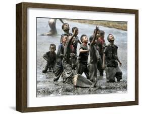 Refugee Children Try to Catch Relief Goods Tossed from an Australian Military Helicopter-null-Framed Premium Photographic Print