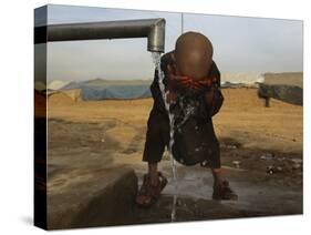 Refugee Washes His Face in a Refugee Camp in the Outskirts of Kabul, Afghanistan-null-Stretched Canvas