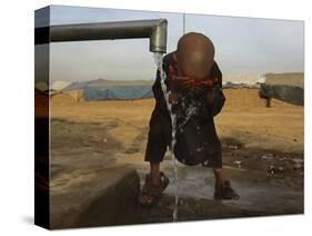 Refugee Washes His Face in a Refugee Camp in the Outskirts of Kabul, Afghanistan-null-Stretched Canvas