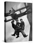 Relief Workers Hanging from Cable in Front of a Giant Beam During the Construction of Fort Peck Dam-Margaret Bourke-White-Stretched Canvas