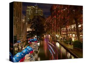 Restaurant Along a River Lit Up at Dusk, San Antonio River, San Antonio, Texas, USA-null-Stretched Canvas