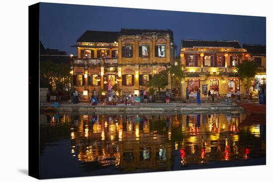 Restaurants and tourists reflected in Thu Bon River at dusk, Hoi An, Vietnam-David Wall-Stretched Canvas