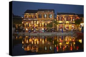 Restaurants and tourists reflected in Thu Bon River at dusk, Hoi An, Vietnam-David Wall-Stretched Canvas