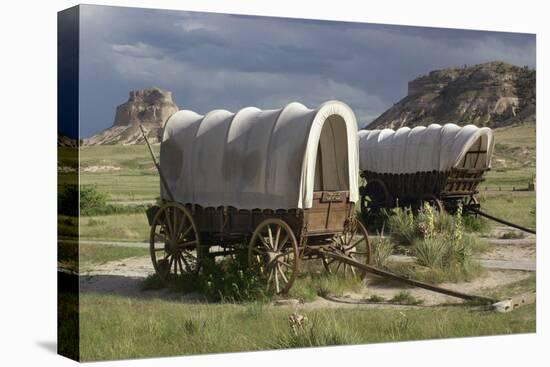 Restored Covered Wagons (Conestoga Wagon at Rear), at Scotts Bluff on the Oregon Trail in Nebraska-null-Stretched Canvas
