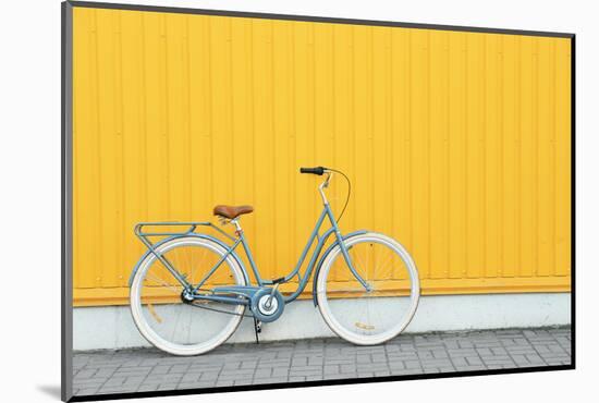 Retro Bicycle near Yellow Wall Outdoors-Africa Studio-Mounted Photographic Print
