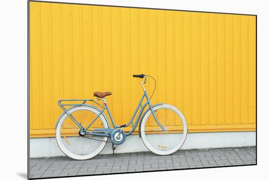 Retro Bicycle near Yellow Wall Outdoors-Africa Studio-Mounted Photographic Print