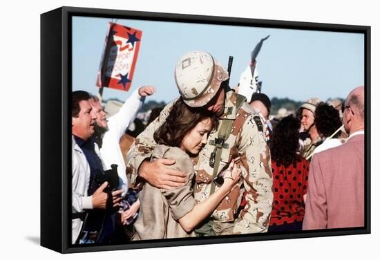 Returning US Soldier Hugs Loved One Amid Other Celebrating Families and Friends-null-Framed Stretched Canvas