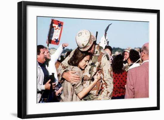 Returning US Soldier Hugs Loved One Amid Other Celebrating Families and Friends-null-Framed Photo