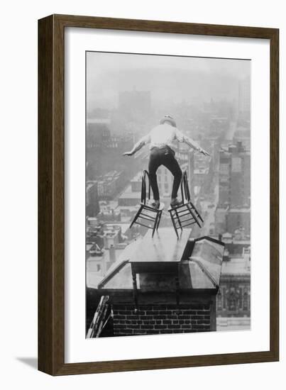 Reynolds Performs a Balancing Act on Roof in New York City-null-Framed Art Print