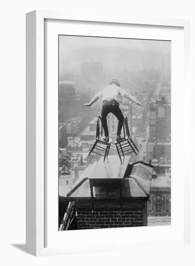 Reynolds Performs a Balancing Act on Roof in New York City-null-Framed Art Print