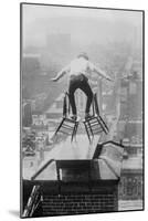 Reynolds Performs a Balancing Act on Roof in New York City-null-Mounted Art Print