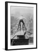 Reynolds Performs a Balancing Act on Roof in New York City-null-Framed Art Print