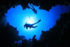 Scuba Diver Swims over Underwater Cave, Silhouette against Sun-Rich Carey-Framed Photographic Print