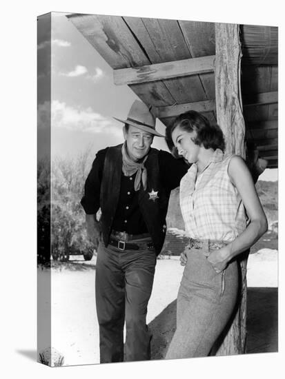 RIO BRAVO, 1959 directed by HOWARD HAWKS On the set, John Wayne and Angie Dickinson (b/w photo)-null-Stretched Canvas