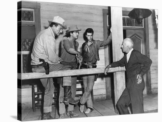 RIO BRAVO, 1959 directed by HOWARD HAWKS On the set, John Wayne, Dean Martin and Ricky Nelson with -null-Stretched Canvas