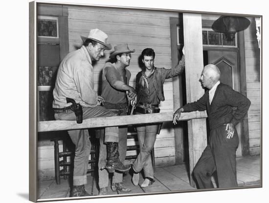 RIO BRAVO, 1959 directed by HOWARD HAWKS On the set, John Wayne, Dean Martin and Ricky Nelson with -null-Framed Photo