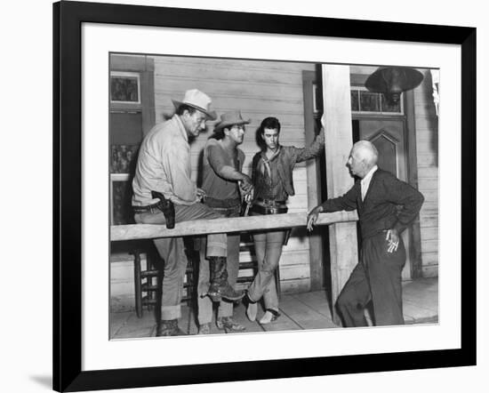 RIO BRAVO, 1959 directed by HOWARD HAWKS On the set, John Wayne, Dean Martin and Ricky Nelson with -null-Framed Photo