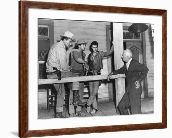 RIO BRAVO, 1959 directed by HOWARD HAWKS On the set, John Wayne, Dean Martin and Ricky Nelson with -null-Framed Photo