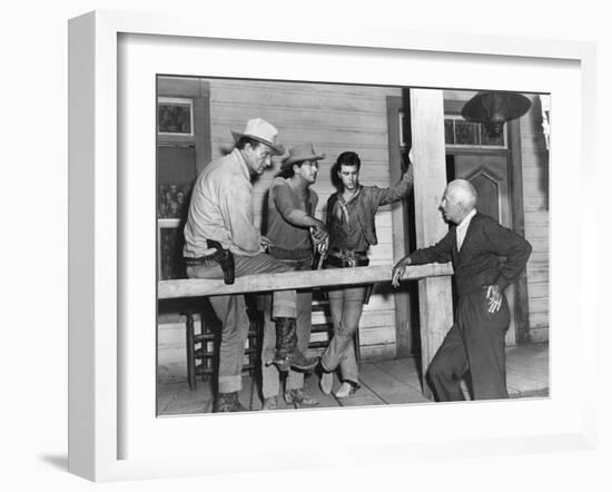 RIO BRAVO, 1959 directed by HOWARD HAWKS On the set, John Wayne, Dean Martin and Ricky Nelson with -null-Framed Photo