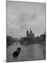 River Barge Churning up the Seine Past Notre Dame Cathedral on a Gloomy Winter Day-Ed Clark-Mounted Photographic Print