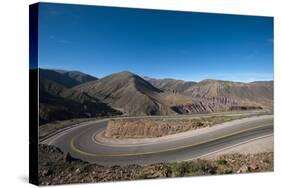 Road leading towards the Salinas Grandes (salt flats) near Purmamarca, Argentina, South America-Alex Treadway-Stretched Canvas