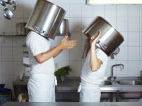 Two Chefs Having Discussion with Large Pans on their Heads-Robert Kneschke-Laminated Photographic Print