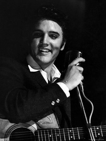 Rock Elvis Presley Performing One of His Hits on Stage During Concert