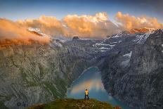 Man standing on rocks looking at clouds at sunset over lake Limmernsee, aerial view-Roberto Moiola-Photographic Print