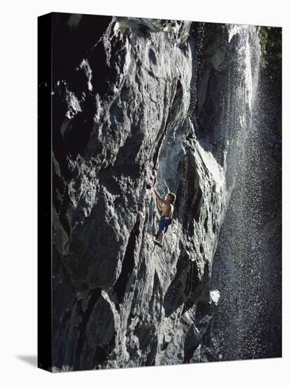 Rock Climber Near a Waterfall-null-Stretched Canvas