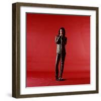 Rock Star Jim Morrison of the Doors Holding Microphone Alone as He Stands Against a Red Backdrop-Yale Joel-Framed Premium Photographic Print