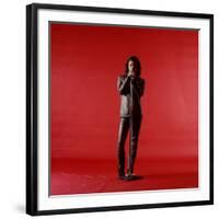 Rock Star Jim Morrison of the Doors Holding Microphone Alone as He Stands Against a Red Backdrop-Yale Joel-Framed Premium Photographic Print