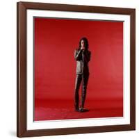 Rock Star Jim Morrison of the Doors Holding Microphone Alone as He Stands Against a Red Backdrop-Yale Joel-Framed Premium Photographic Print