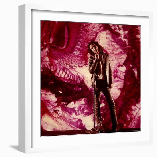 Rock Star Jim Morrison of the Doors Standing Alone in Front of a Purple Psychedelic Backdrop-Yale Joel-Framed Premium Photographic Print