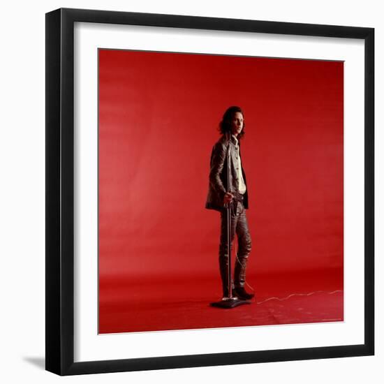 Rock Star Jim Morrison of the Doors Standing Alone Next to Microphone in Front of a Red Backdrop-Yale Joel-Framed Premium Photographic Print