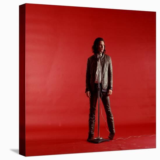 Rock Star Jim Morrison of the Doors Standing Behind Microphone Alone Against a Red Backdrop-Yale Joel-Stretched Canvas